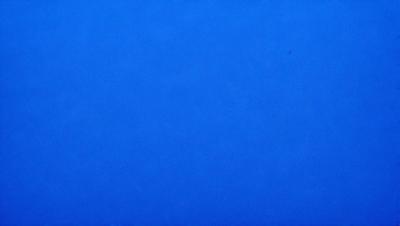 The primary subject of the image is a large, open body of water, which appears to be a deep blue ocean. The setting is a vast, empty sky, with no visible land or other objects. The visual style of the image is a photo, capturing the beauty of the ocean and the vastness of the sky. The colors and mood of the image are predominantly blue, creating a serene and peaceful atmosphere.