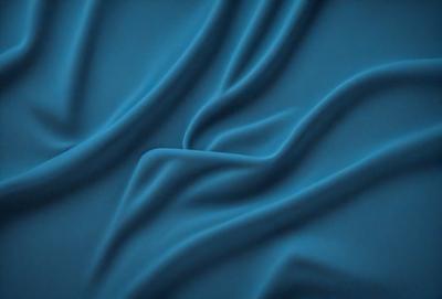 The primary subject of the image is a blue fabric, which appears to be a piece of cloth or a curtain. The setting is a dark room, and the visual style is a close-up of the blue fabric. The colors and mood of the image are predominantly blue, creating a calm and serene atmosphere.