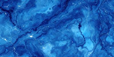The primary subject of the image is a blue and white marble-like surface, which appears to be a patterned or textured material. The setting is a blue background, which complements the blue and white colors of the surface. The visual style of the image is a close-up of the marble-like surface, showcasing its intricate patterns and textures. The colors and mood of the image are predominantly blue and white, creating a serene and elegant atmosphere.