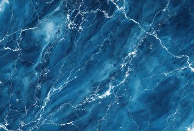 The primary subject of the image is a blue marble wall with a pattern of white and blue swirls. The setting is a room with a blue marble floor. The visual style is a close-up of the marble wall, showcasing the intricate pattern. The colors and mood of the image are predominantly blue, creating a calm and serene atmosphere.