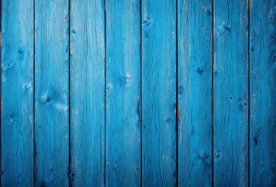 The primary subject of the image is a blue wooden wall. The setting is a room with a blue wooden wall, and the visual style is a photo. The dominant colors are blue and white, creating a calm and serene atmosphere.
