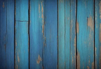 The primary subject of the image is a blue wooden wall with a peeling paint surface. The setting is a room with a blue and white color scheme. The visual style is a close-up of the wooden wall, showcasing the peeling paint and the blue and white color combination. The colors and mood of the image are predominantly blue and white, creating a calm and serene atmosphere.