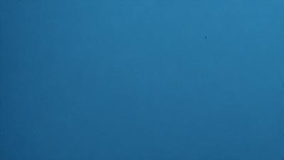 The primary subject of the image is the sky, which is a deep blue color. The setting is a vast, open space with no visible landmarks or objects. The visual style is a natural, outdoor scene. The colors and mood convey a sense of tranquility and calmness.