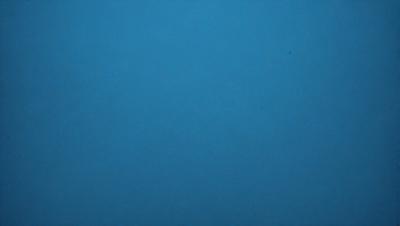 The primary subject of the image is a large, open, and dark blue sky. The setting is a vast, empty space with no visible landmarks or objects. The visual style is a natural, untouched, and unaltered representation of the sky. The colors and mood convey a sense of tranquility and vastness.