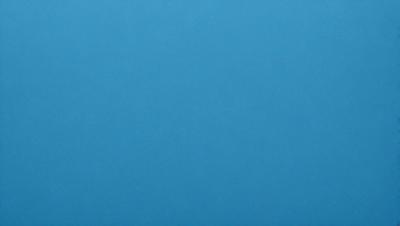 The primary subject of the image is a large, open, and empty blue sky. The setting is a vast, cloudless expanse, with no visible landmarks or objects. The visual style is a natural, untouched landscape, with no indication of digital manipulation or artistic elements. The colors and mood are predominantly blue, creating a serene and tranquil atmosphere.