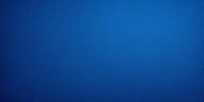 The primary subject of the image is a large, open, and dark blue sky. The setting is a vast, empty space with no visible landmarks or objects. The visual style is a natural, untouched, and unaltered representation of the sky. The colors and mood convey a sense of tranquility and vastness.