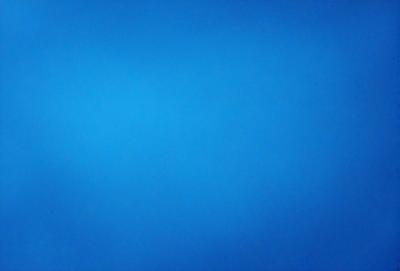 The primary subject of the image is a large, open, and dark blue sky. The setting is a vast, empty space with no visible landmarks or objects. The visual style is a natural, untouched, and unaltered representation of the sky. The colors and mood convey a sense of tranquility and vastness.