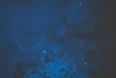 The primary subject of the image is the night sky, which is filled with stars. The setting is a dark, cloudy night, with the sky being the main focus of the image. The visual style is a painting, which adds a sense of depth and artistic expression to the scene. The colors and mood of the image are predominantly dark and moody, with the stars and clouds creating a dramatic and atmospheric backdrop.