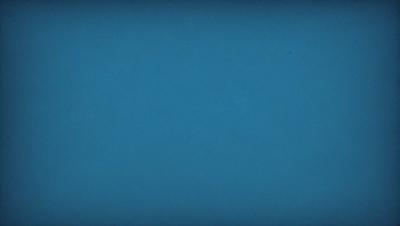 The primary subject of the image is a large, dark blue sky. The setting is a vast, open space with no visible landmarks or objects. The visual style is a natural, untouched landscape. The colors and mood are predominantly dark and moody, with the blue sky serving as the main focal point.