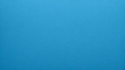 The primary subject of the image is a large, open, and empty blue sky. The setting is a vast, cloudless expanse, with no visible landmarks or objects. The visual style is a natural, untouched landscape, with no indication of digital manipulation or artistic elements. The colors and mood are predominantly blue, conveying a sense of tranquility and vastness.