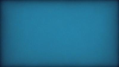 The primary subject of the image is a large, dark blue sky. The setting is a vast, open space with no visible landmarks or objects. The visual style is a natural, untouched landscape. The colors and mood are predominantly dark and moody, with the blue sky serving as the main focal point.