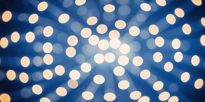 The primary subject of the image is a bright light source, possibly a light bulb or a star, surrounded by a multitude of small lights. The setting is a dark background, which contrasts with the bright light source. The visual style appears to be a combination of a photo and a digital art or illustration, as the light source is depicted in a realistic manner, while the surrounding small lights are depicted in a more stylized manner. The colors and mood of the image are predominantly bright and lively