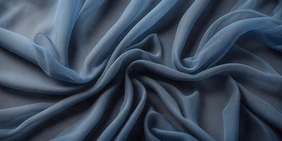 The primary subject of the image is a blue fabric, which appears to be a piece of cloth or a curtain. The setting is a dark background, which contrasts with the blue fabric. The visual style is a close-up of the fabric, showcasing its texture and details. The colors and mood of the image are predominantly blue, creating a calm and serene atmosphere.