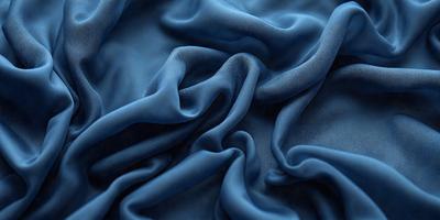 The primary subject of the image is a blue fabric, which appears to be a piece of cloth or a sheet. The setting is a room with a blue background, which creates a cohesive and visually appealing environment. The visual style of the image is a close-up of the blue fabric, showcasing its texture and details. The colors and mood of the image are predominantly blue, giving it a calm and serene atmosphere.