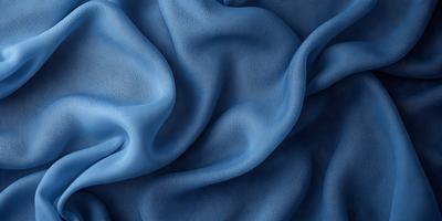 The primary subject of the image is a blue fabric, which is the main object, scene, or focus of the image. The setting or background is a blue cloth, and the visual style is a photo. The dominant colors and overall atmosphere are blue and serene.