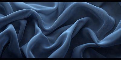 The primary subject of the image is a blue fabric, possibly a piece of cloth or a curtain. The setting is a dark room, and the visual style appears to be a close-up of the fabric. The colors and mood of the image are predominantly dark and moody, with the blue fabric being the main focus.