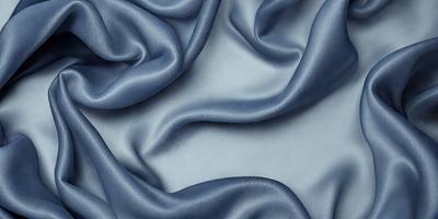 The primary subject of the image is a blue fabric, which is the main object, scene, or focus of the image. The setting or background is a white surface, and the visual style is a photo. The dominant colors are blue and white, creating a calm and serene atmosphere.