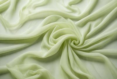 The primary subject of the image is a close-up of a green fabric, possibly a piece of cloth or a curtain. The setting is a white background, which provides a clean and minimalistic appearance. The visual style is a combination of a photo and a digital art, as the green fabric appears to be a digital creation. The colors and mood of the image are predominantly green, giving it a calm and soothing atmosphere.