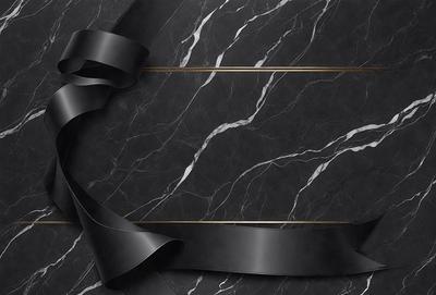 The primary subject of the image is a black bow, which is tied around a marble surface. The setting is a black and white marble countertop, and the visual style is a close-up of the bow. The colors and mood of the image are predominantly black and white, giving it a classic and elegant appearance.