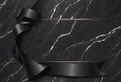 The primary subject of the image is a black bow, which is tied around a marble surface. The setting is a black and white marble countertop, and the visual style is a close-up of the bow. The colors and mood of the image are predominantly black and white, giving it a classic and elegant appearance.