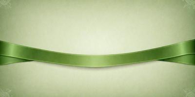 The primary subject of the image is a green ribbon. The ribbon is displayed on a green background, which creates a cohesive and visually appealing scene. The visual style of the image is a close-up of the green ribbon, emphasizing its color and texture. The overall atmosphere of the image is calm and serene, as the green ribbon is the main focus and the background provides a soothing and natural backdrop.