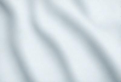 The primary subject of the image is a white wall with a pattern of zigzag lines. The setting is a room with a white background, and the visual style appears to be a photo. The dominant colors are white and gray, creating a clean and minimalist atmosphere.