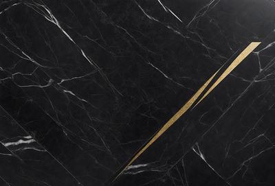 The primary subject of the image is a black marble countertop with a gold stripe. The setting is a kitchen, and the visual style is a close-up of the marble countertop. The dominant colors are black and gold, creating a luxurious and elegant atmosphere.