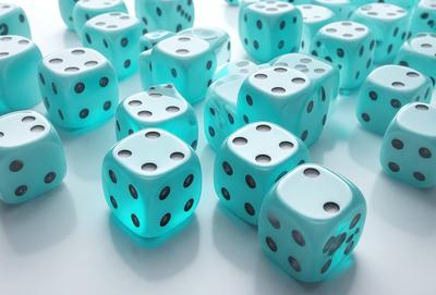 The primary subject of the image is a collection of blue and white dice. The setting is a white surface, and the visual style is a close-up of the dice. The colors and mood of the image are predominantly blue and white, giving it a clean and organized appearance.