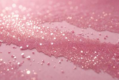 The primary subject of the image is a close-up of a pink surface with glittery, sparkling pink glitter on it. The setting appears to be a table or a similar surface. The visual style of the image is a close-up of the glittery pink surface, which gives it a unique and eye-catching appearance. The colors and mood of the image are predominantly pink, with the glittery pink glitter adding a touch of sparkle and shine to the scene