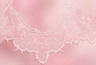 The primary subject of the image is a white lace collar. The setting is a pink background, which creates a contrast with the white lace. The visual style is a close-up of the lace collar, showcasing its intricate details. The colors and mood of the image are predominantly pink, giving it a soft and delicate appearance.