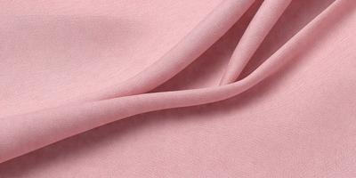 The primary subject of the image is a pink fabric, which is the main object, scene, or focus of the image. The setting is a pink background, and the visual style is a photo. The colors and mood of the image are predominantly pink, creating a warm and inviting atmosphere.