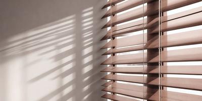 The primary subject of the image is a wooden shutter with blinds, which is located on a wall. The setting is a room with a white wall, and the visual style is a photo. The colors in the image are predominantly brown, and the overall atmosphere is calm and serene.