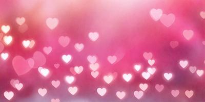 The primary subject of the image is a large number of hearts, which are scattered throughout the scene. The hearts are pink and are arranged in various patterns, creating a visually appealing and heartwarming display. The setting is a pink background, which complements the hearts and adds to the overall mood of the image. The visual style of the image is a combination of photo and digital art, as it features a close-up view of the hearts and a well-defined, artistic arrangement. The colors and mood