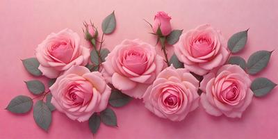 The primary subject of the image is a bouquet of pink roses. The roses are arranged in a visually appealing manner, with some of them placed on a pink surface. The setting appears to be a studio or a controlled environment, as the roses are carefully positioned and displayed. The visual style of the image is a close-up of the roses, emphasizing their beauty and details. The dominant colors in the image are pink, which is the color of the roses, and the pink surface