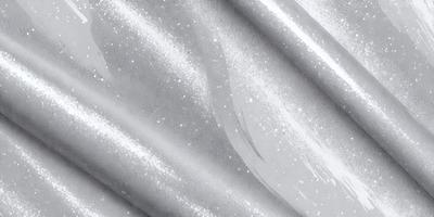 The primary subject of the image is a silver fabric with a metallic sheen. The setting is a close-up view of the fabric, showcasing its texture and shine. The visual style is a realistic representation of the fabric, capturing its unique properties. The colors and mood of the image are predominantly silver and metallic, creating a sense of sophistication and elegance.