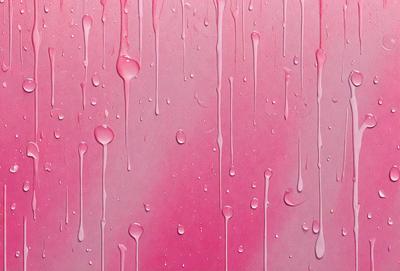 The primary subject of the image is a pink background with droplets of water on it. The setting is a pink wall, and the visual style is a close-up of the pink background with water droplets. The colors and mood of the image are predominantly pink, creating a warm and inviting atmosphere.