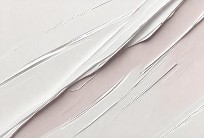 The primary subject of the image is a close-up of a white paper with a creased texture. The paper appears to be a piece of parchment paper. The setting is a table, and the visual style is a close-up of the paper. The colors in the image are predominantly white, giving it a clean and simple appearance.