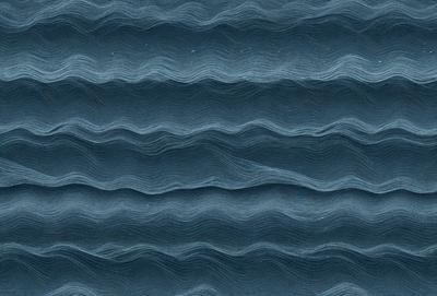 The primary subject of the image is a blue ocean with waves. The setting is the ocean, and the visual style is a photo. The dominant colors are blue and white, creating a calm and serene atmosphere.