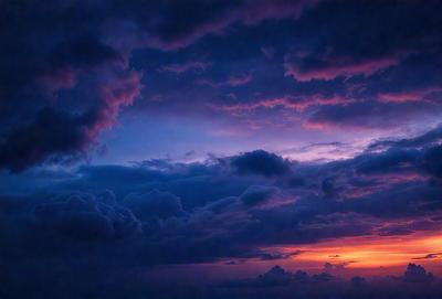 The primary subject of the image is a cloudy sky with a purple hue. The setting is a dark, cloudy night, and the visual style is a photo. The colors and mood of the image are dramatic and moody, with the purple hue adding a sense of mystery to the scene.
