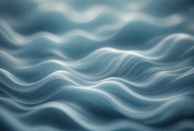 The primary subject of the image is a blue ocean with waves. The setting is the ocean, and the visual style is a photo. The dominant colors are blue and white, creating a calm and serene atmosphere.