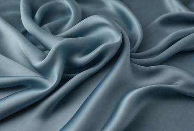 The primary subject of the image is a blue fabric, which is the main object, scene, or focus of the image. The setting or background is a blue cloth, and the visual style is a photo. The dominant colors and overall atmosphere are blue and gray, creating a calm and soothing mood.