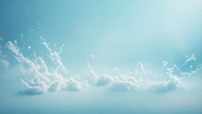 The primary subject of the image is a cloudy blue sky with a few white clouds. The setting is a vast, open sky, and the visual style is a natural, outdoor atmosphere. The colors and mood of the image are predominantly blue and serene, creating a peaceful and tranquil scene.