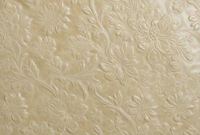 The primary subject of the image is a wall with a pattern of flowers. The setting is a room with a white background. The visual style is a combination of photo and digital art, creating a realistic yet artistic representation of the flowers. The colors and mood are predominantly white, giving the scene a clean and elegant appearance.