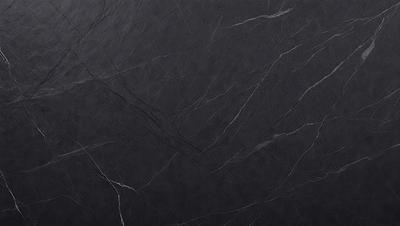The primary subject of the image is a black marble countertop. The setting is a kitchen, with the countertop being the main focus of the scene. The visual style is a close-up of the marble countertop, showcasing its texture and pattern. The colors and mood of the image are predominantly dark, with the black marble countertop being the main source of contrast.