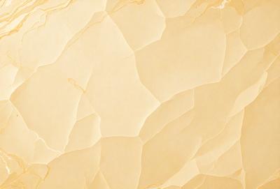 The primary subject of the image is a yellow marble wall with a patterned texture. The setting is a room with a yellow marble wall as the main focus. The visual style is a close-up of the yellow marble wall, showcasing its unique texture. The colors and mood of the image are warm and inviting, with the yellow marble wall being the main source of color and visual interest.