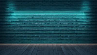 The primary subject of the image is a brick wall. The setting is a dark room with a blue light illuminating the wall. The visual style is a photo, and the colors and mood are predominantly dark and moody.