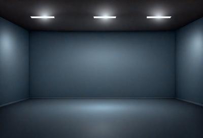 The primary subject of the image is a large, empty room with a blue wall. The setting is a dark room with a blue wall, and the visual style is a black and white photo. The colors and mood of the image are predominantly dark and moody, with the blue wall providing a contrasting element.