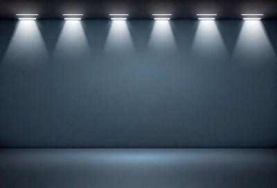 The primary subject of the image is a blue wall with a row of lights shining on it. The setting is a dark room, and the visual style is a black and white photo. The dominant colors are blue and white, creating a calm and serene atmosphere.