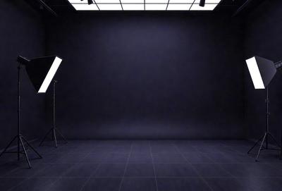 The primary subject of the image is a black background with a white light shining on it. The setting is a dark room, and the visual style is a black and white photo. The colors and mood of the image are predominantly dark and moody, with the white light creating a stark contrast against the black background.