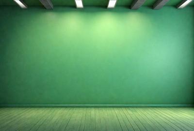 The primary subject of the image is a green wall with a white border. The setting is a room with a wooden floor. The visual style is a photo, and the dominant colors are green and white. The overall atmosphere is clean and minimalistic.